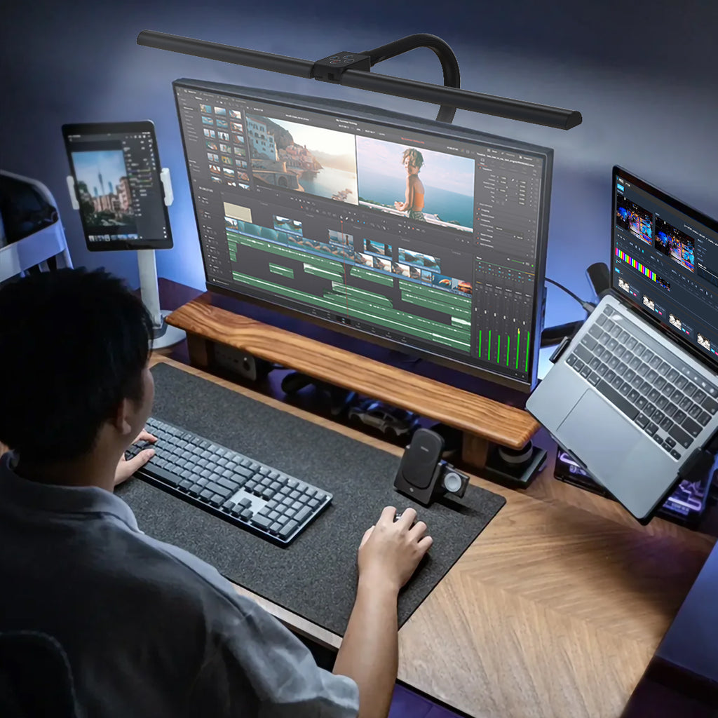 Nerius Axis Base desk lamp illuminating workspace for video editing, with tablet, laptop, and monitor on desk, ideal for home or office use
