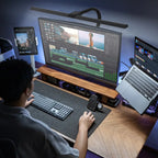 Nerius Axis Base desk lamp illuminating workspace for video editing, with tablet, laptop, and monitor on desk, ideal for home or office use